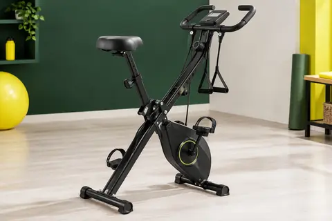 Vélo d’appartement pliable noir avec écran LCD, selle réglable et bandes de résistance intégrées.