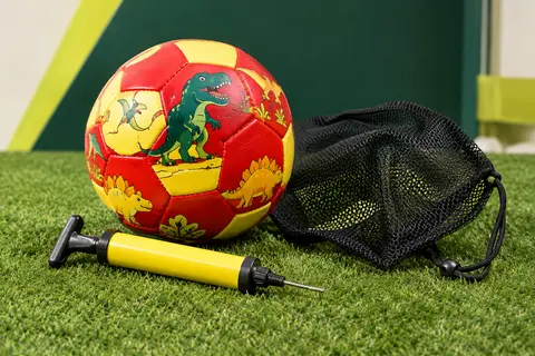 Ballon de football enfant taille 3 rouge et jaune à motif dinosaure, avec pompe à main et sac en filet.